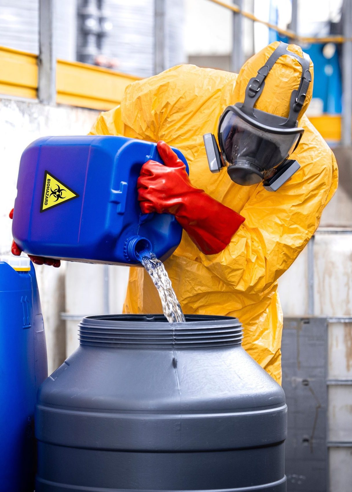 Factory,Worker,Wearing,Yellow,Protection,Suit,And,Gas,Mask,Working